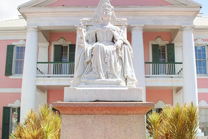 Parliament Square. Pink colonial -style government buildings in Rawson Square with a marble statue of Queen Victoria enthroned out front.