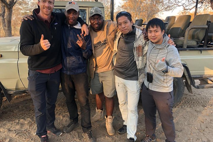 David (guide) posing with guests after a successful camping trip