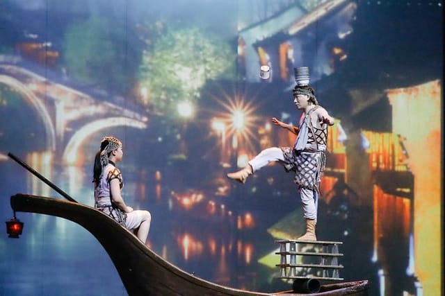 Shanghai Circus World performer balancing objects on his head during the 'ERA Intersection of Time' show.