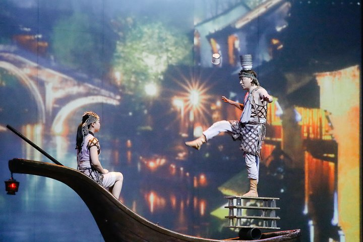 Shanghai Circus World performer balancing objects on his head during the 'ERA Intersection of Time' show.