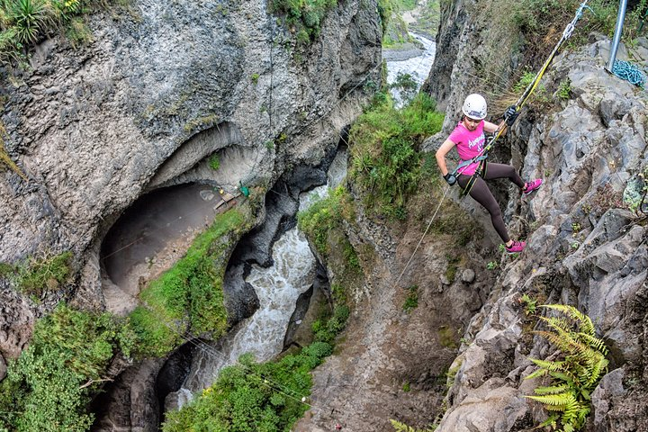 Descent in a guided rappel of 60 meters by a basalt wall