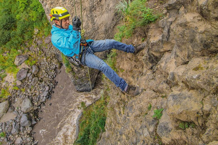 Descent in a rappel of 70 meters in a basalt wall