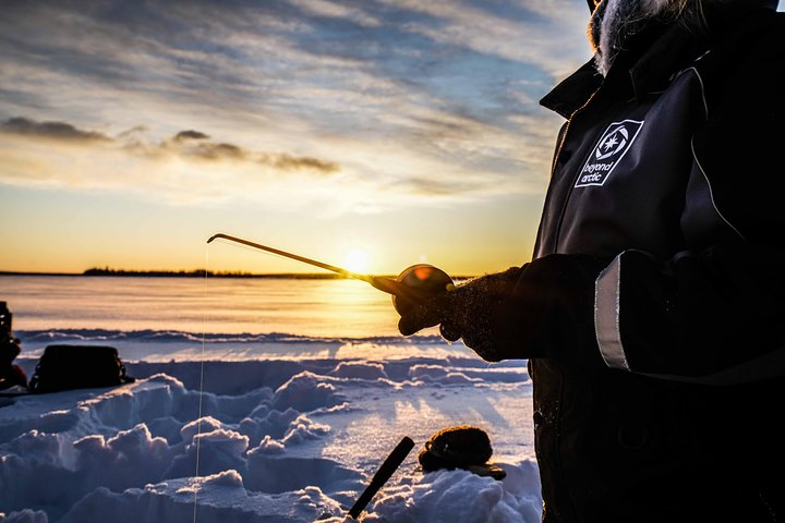 Ice fishing on a frozen lake - Photo 1 of 5