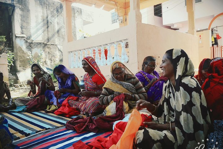 artisans in groups doing embroidery