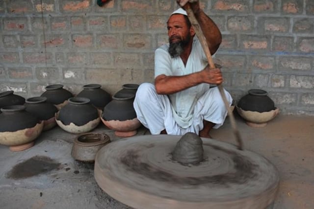 Artist making clay pot