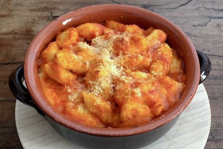 Gnocchi with tomato sauce cooked in a brick oven