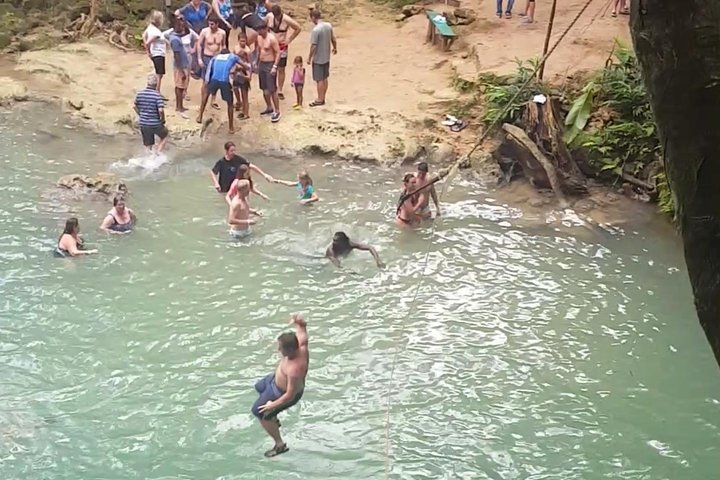 Plunging into the water at the Blue Hole from the Tarzan Rope swing.