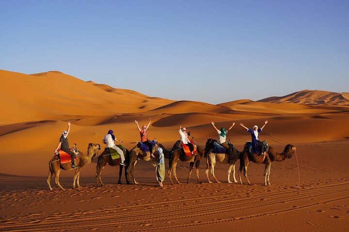 Riding camels to our overnight camp in the Sahara