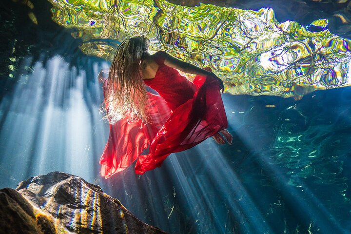 beautiful sun rays in the cenote during our underwater photo shoot in the cenote of Tulum
