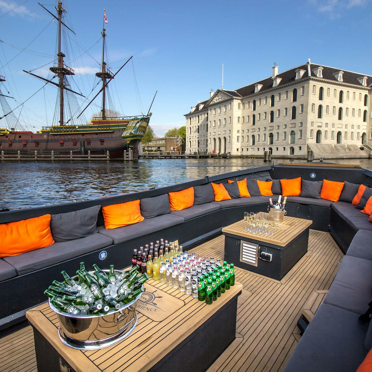 Glide through Amsterdam's historic canals aboard a luxurious boat soaking in stunning views of iconic landmarks while enjoying insightful commentary and delightful refreshments along the way.