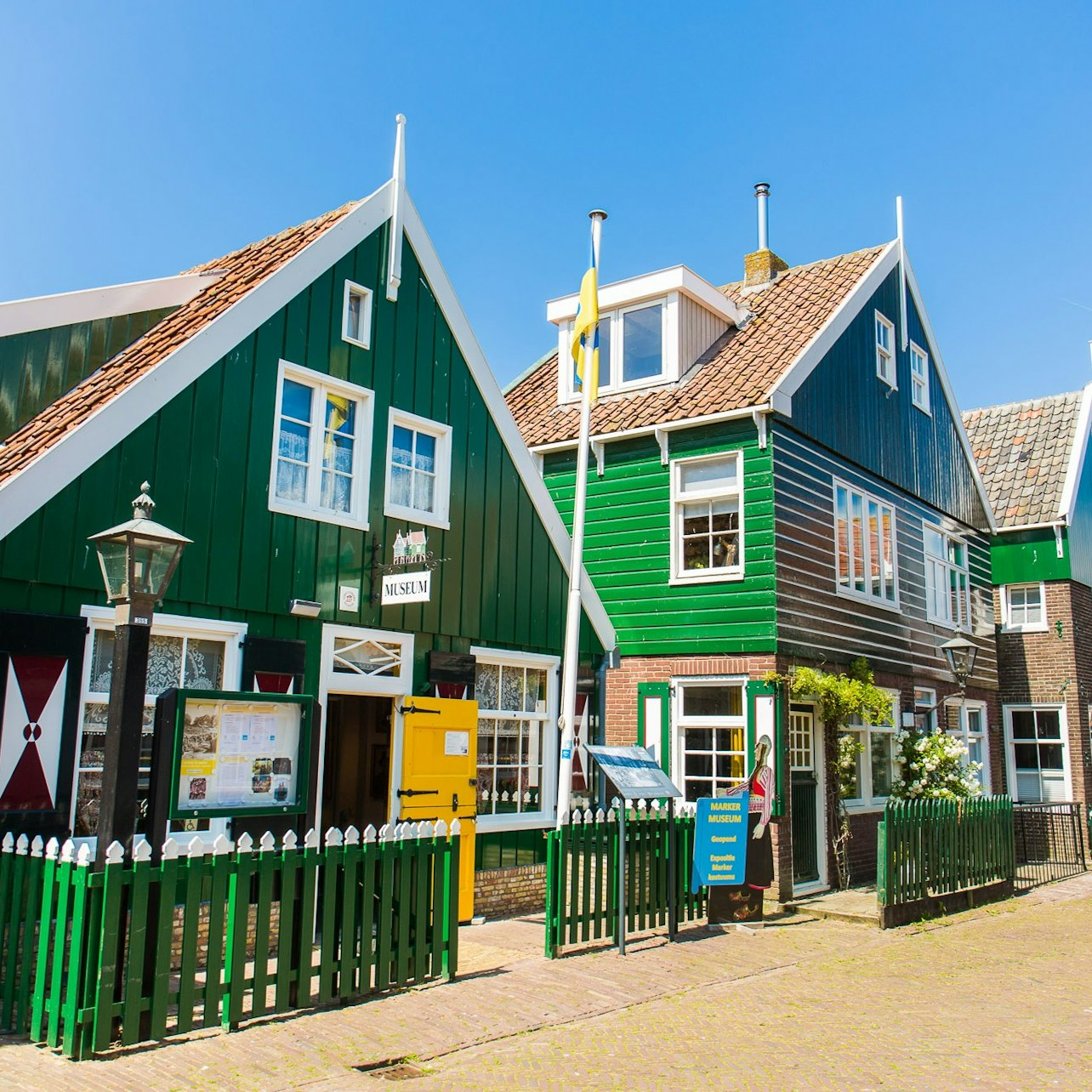 Explore charming green wooden houses and quaint streets in Marken where traditional Dutch culture thrives amid stunning landscapes offering a unique glimpse into the Netherlands' rich heritage.