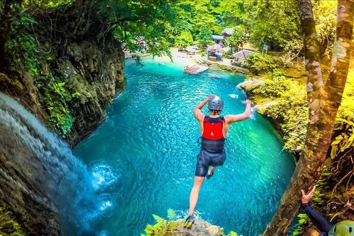 Experience the adrenaline rush as you jump through the turquoise waters in canyoneering badian.