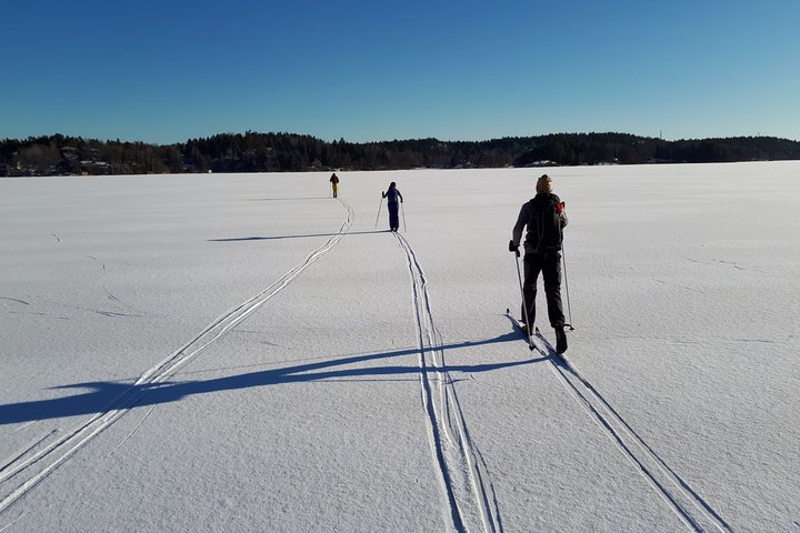 Cross country skiing on a frozen lake covered in snow