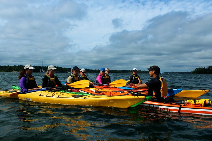 Instructor teaching a group about kayak basics