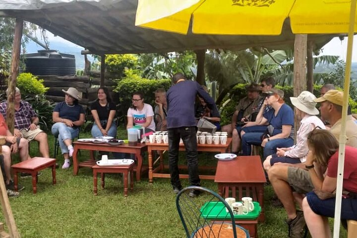 Visitors enjoying a cup of coffee after completing the coffee-making experience at a local farm near Kisoro town